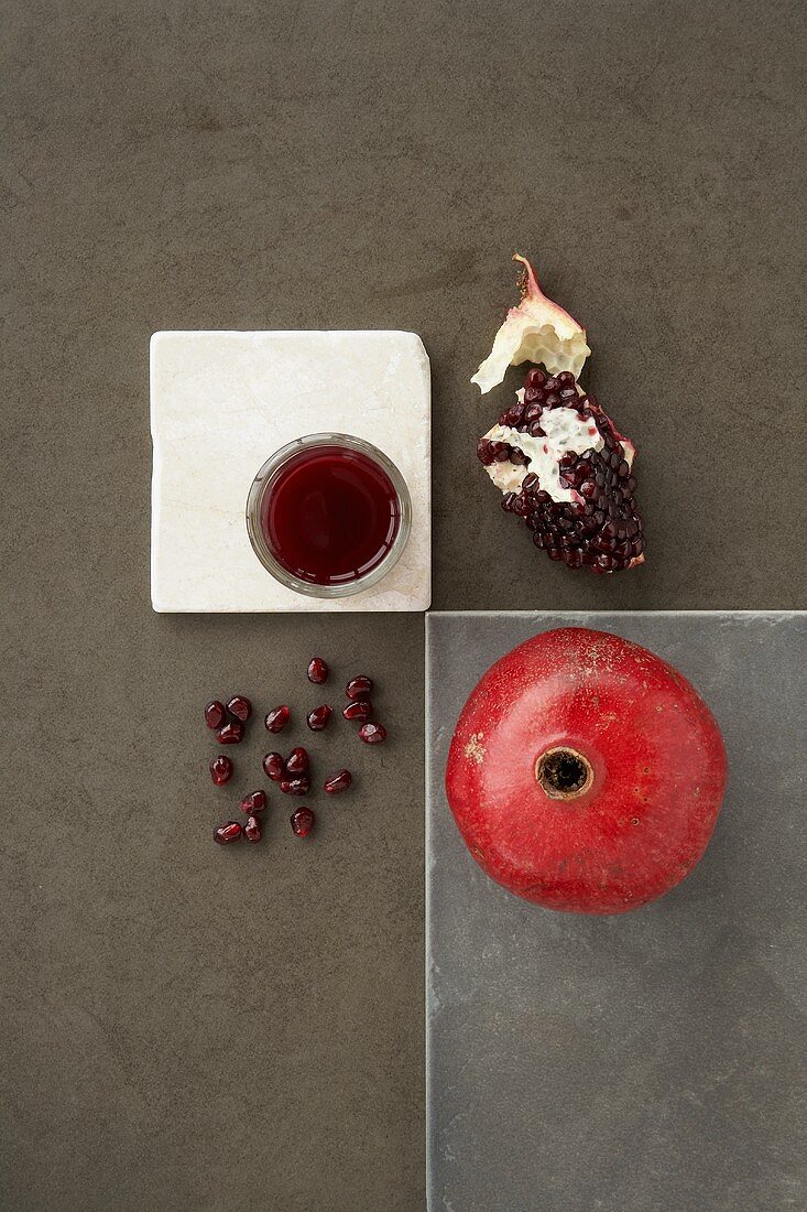 A Whole Pomegranate with Core, Seeds and Juice