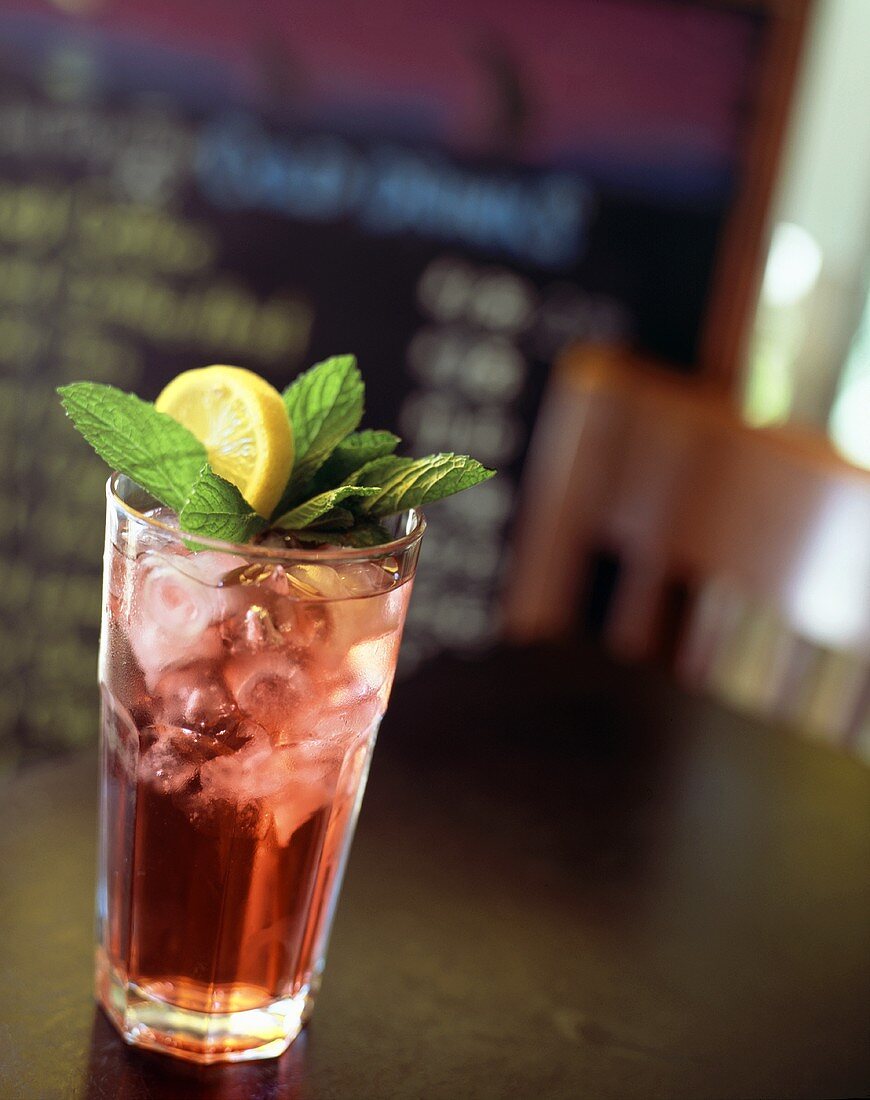 A Glass of Raspberry Iced Tea with Mint and Lemon