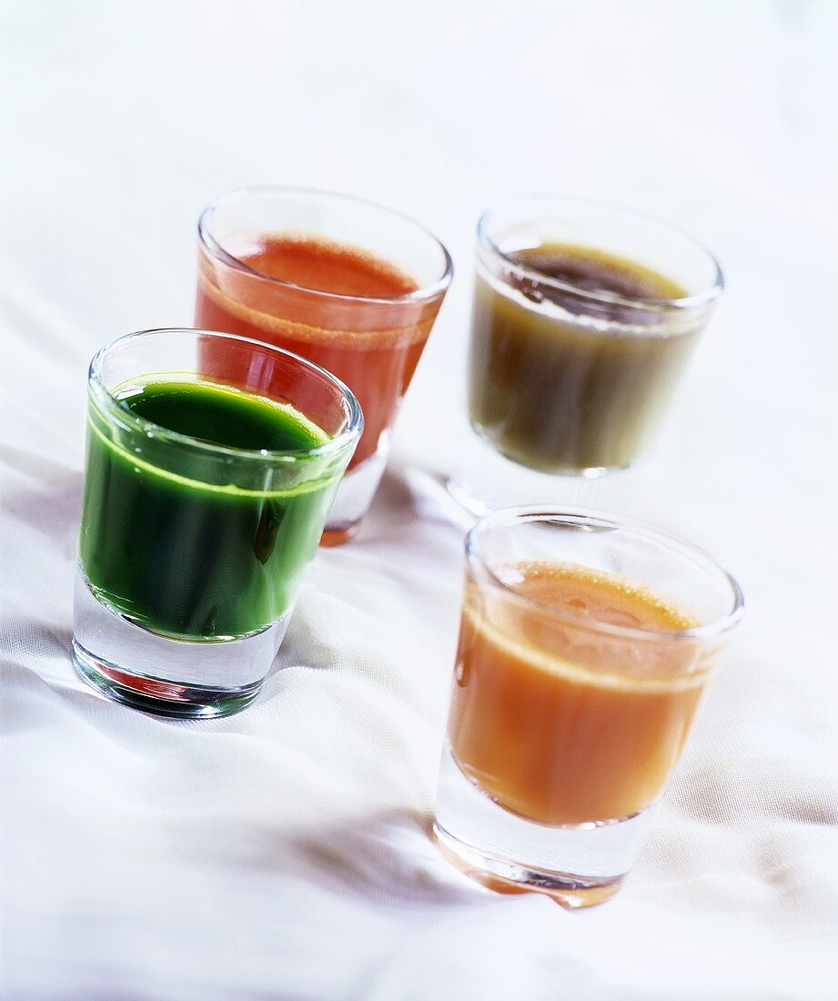 Four shots of vegetable juice