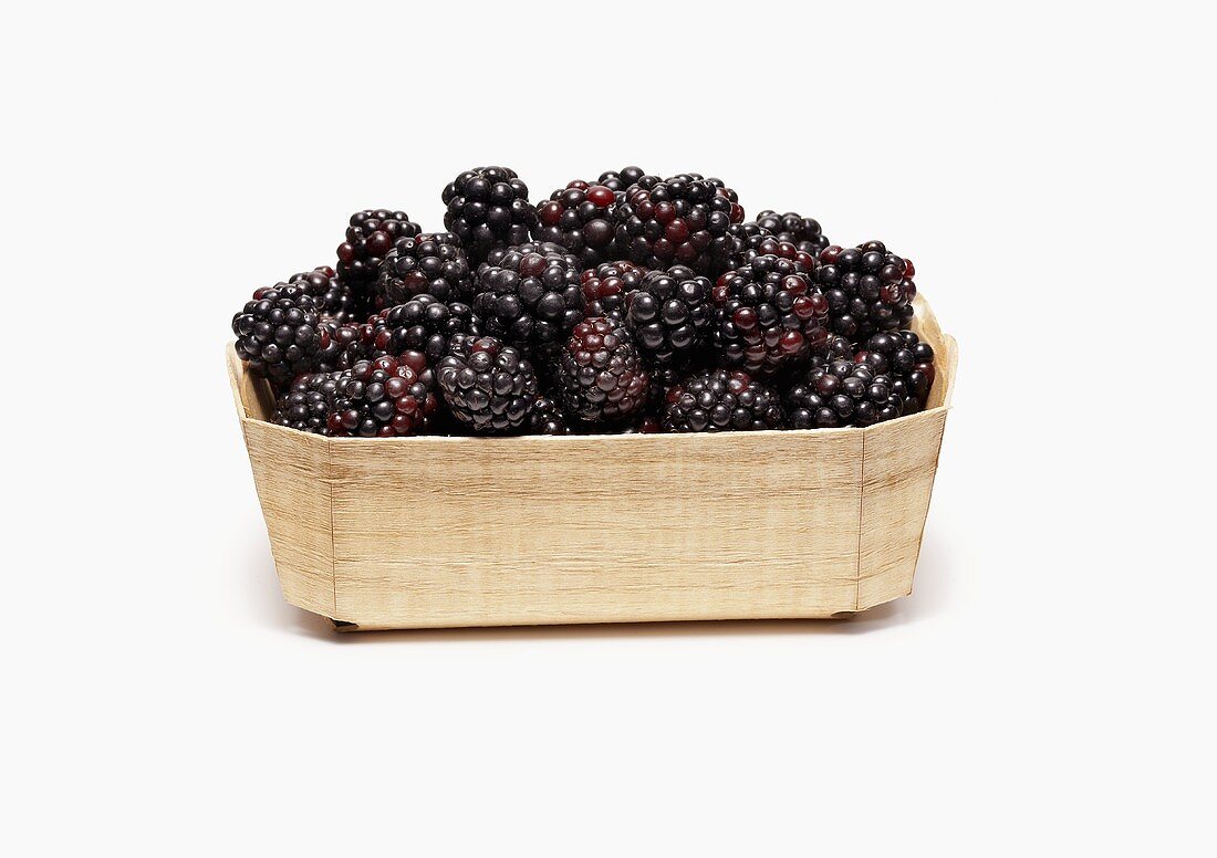 Wooden Basket Full of Fresh Blackberries on White Background