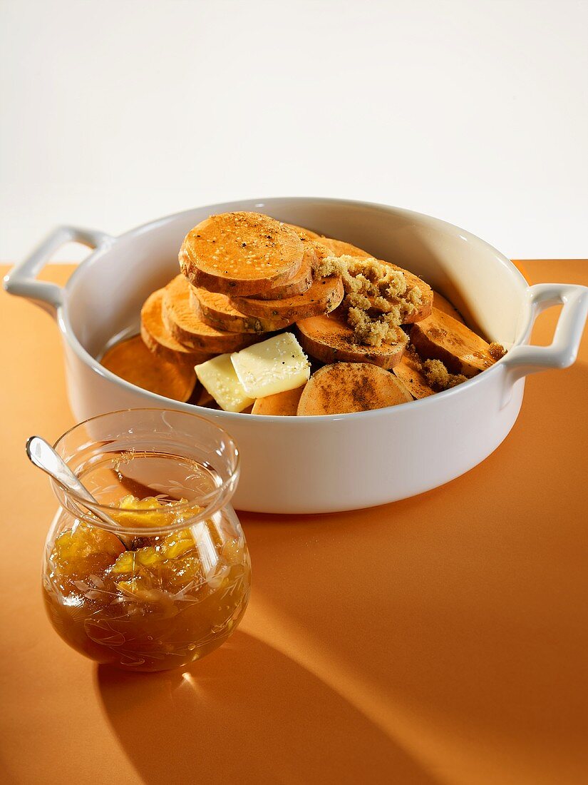 Sliced Uncooked Sweet Potatoes in a Pot with Butter and Brown Sugar; Orange Marmalade