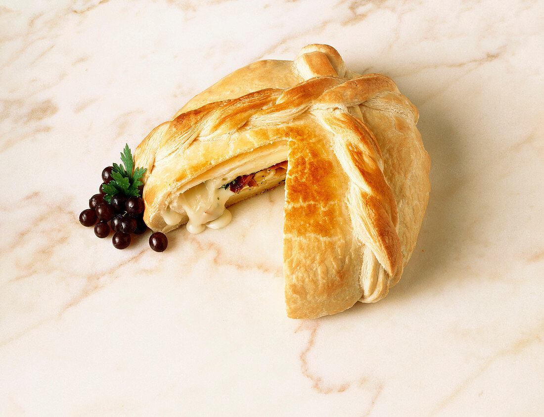 Cheese Melting From Sliced Loaf of Stuffed Bread; Grapes