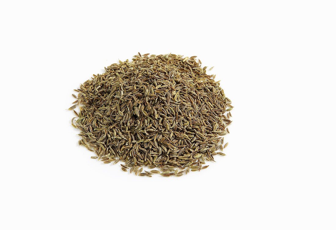Pile of Whole Cumin Seeds on White Background