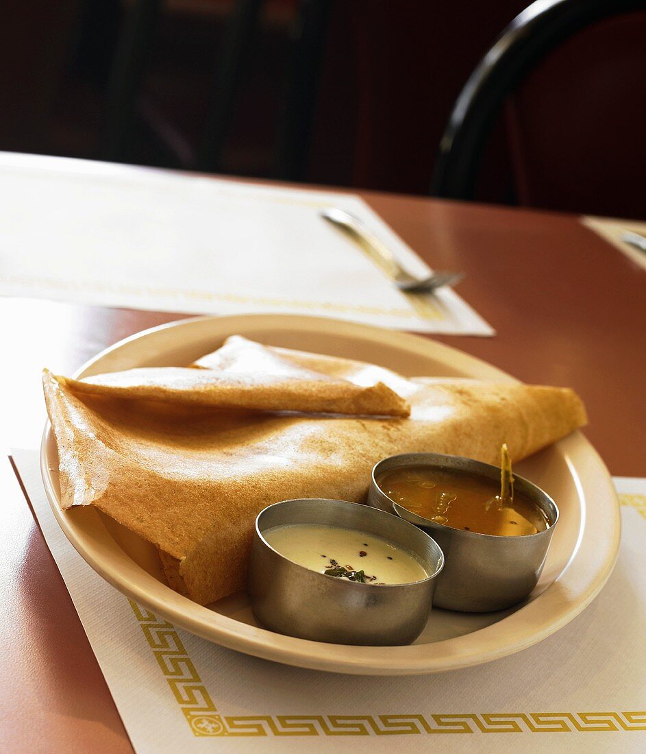 Serving of Indian Dosa with Two Assorted Sauces; In a Restaurant
