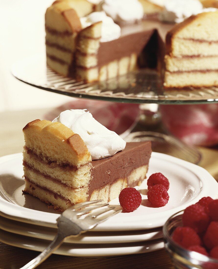 Sponge cake with raspberry jam, chocolate cream and cream
