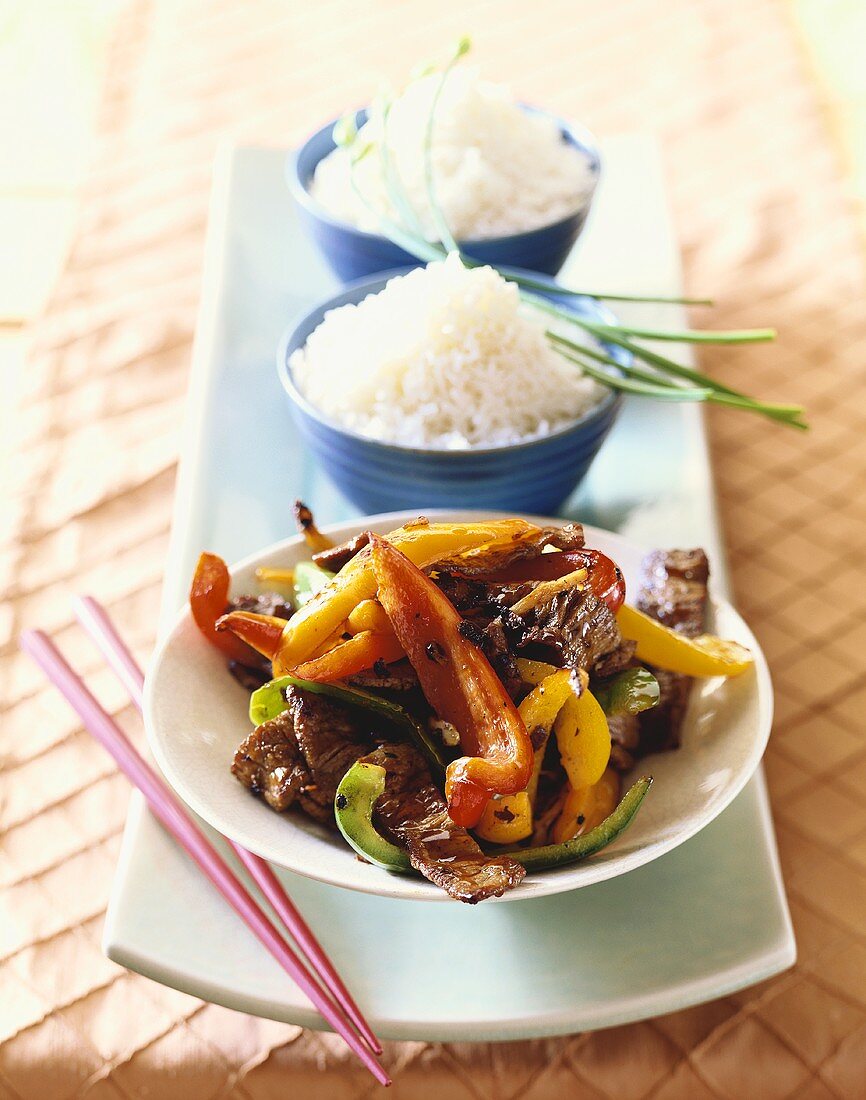 Platter with Bowl of Beef and Bell Pepper Stir Fry and Two Bowls of Rice; Chopsticks