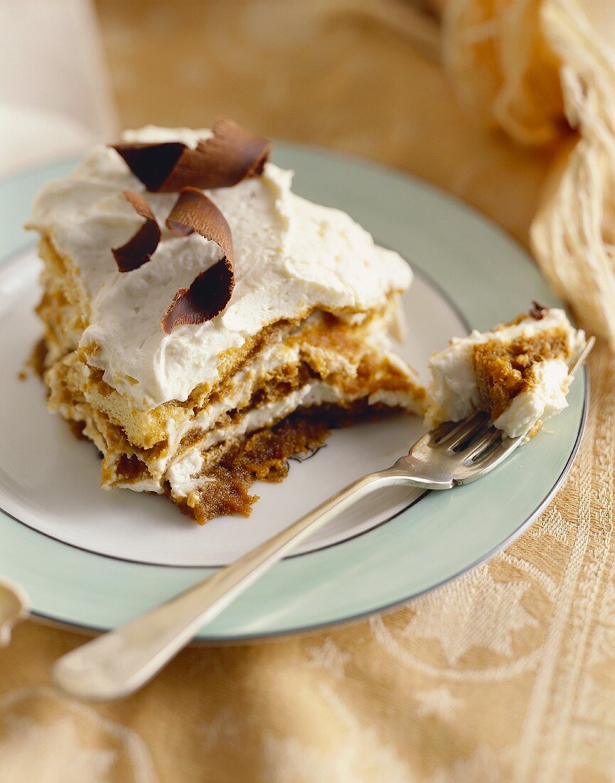 Serving of Tiramisu with Chocolate Shavings on a Plate with Fork
