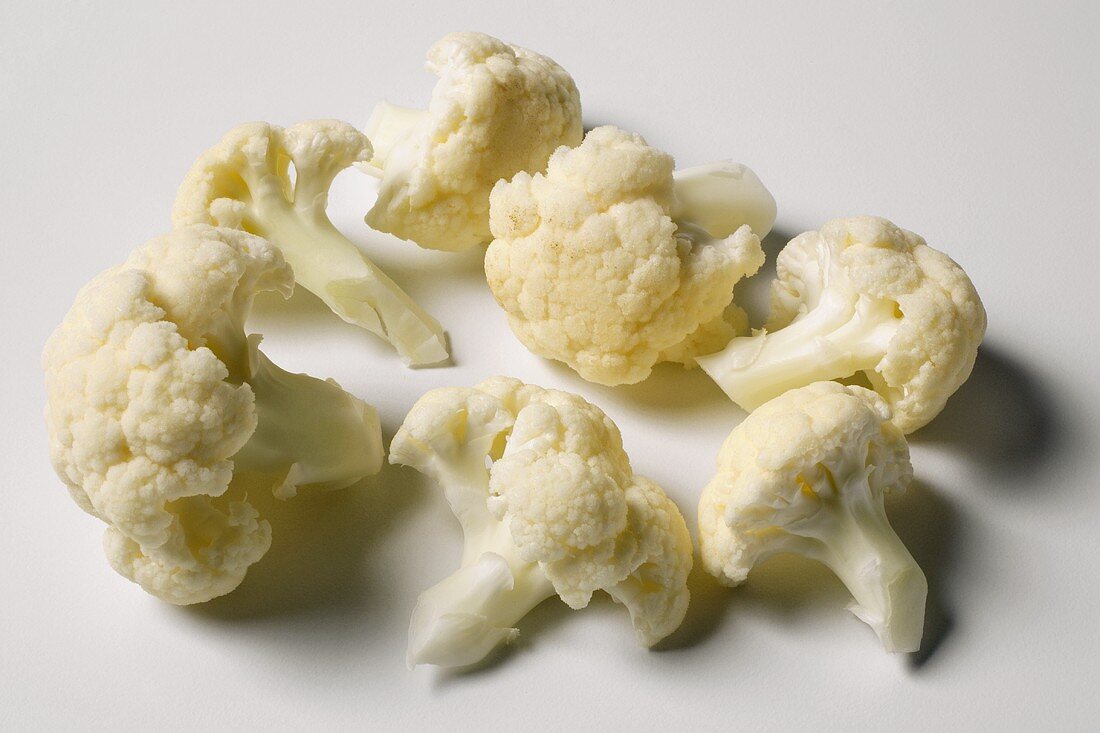 Several pieces of cauliflower on white background