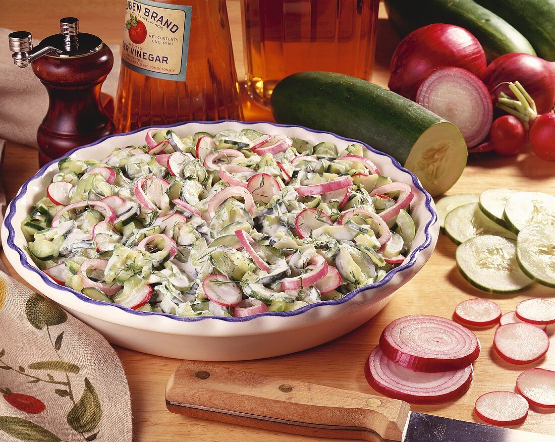 Large Bowl of Cucumber, Radish and Red Onion Salad with Sour Cream Dressing; Fresh Ingredients