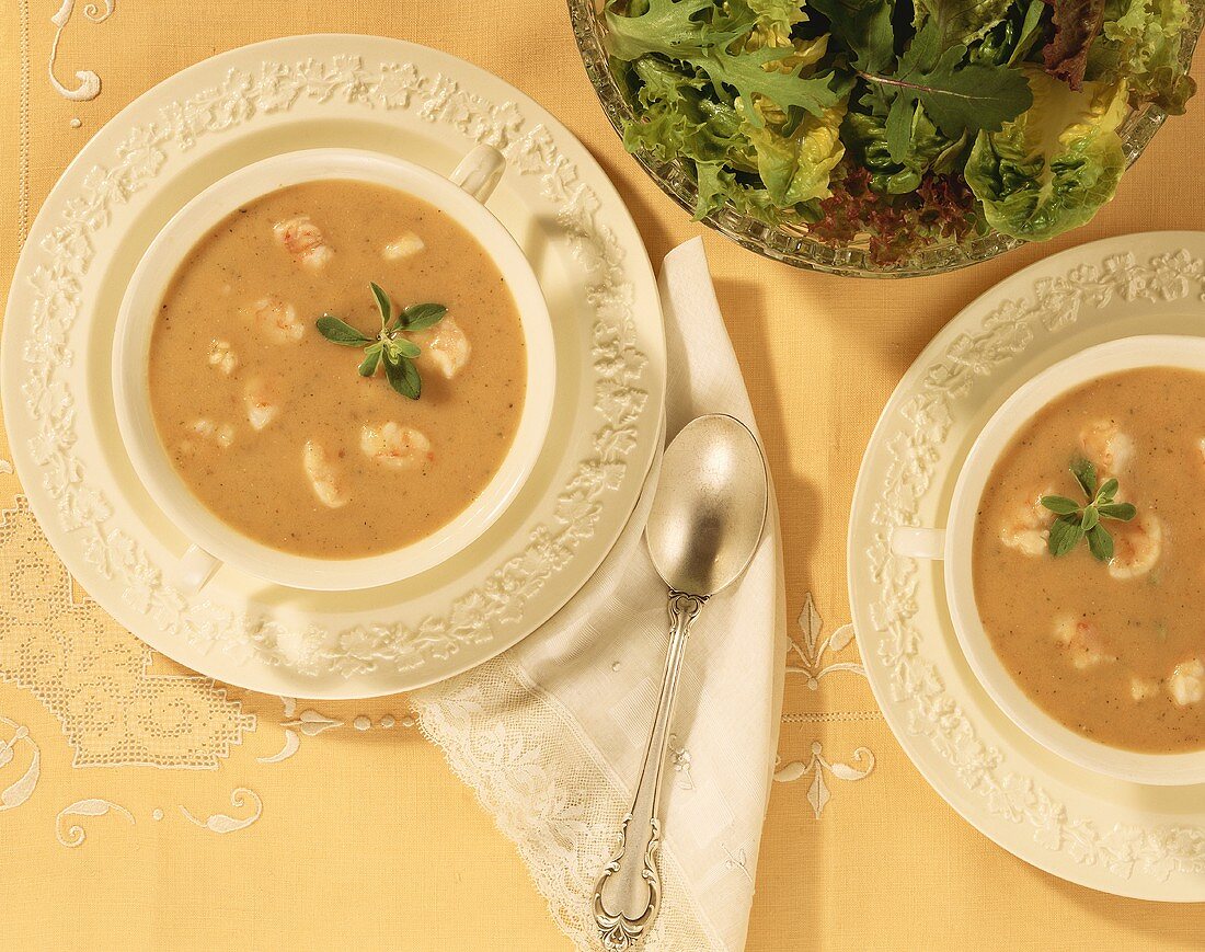 Overhead of Two Bowls of Shrimp Bisque; Salad