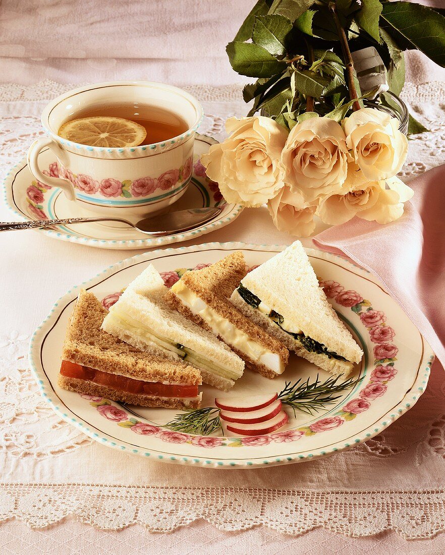 Plate with Assorted Tea Sandwiches; Radish Garnish and Cup of Tea with Lemon