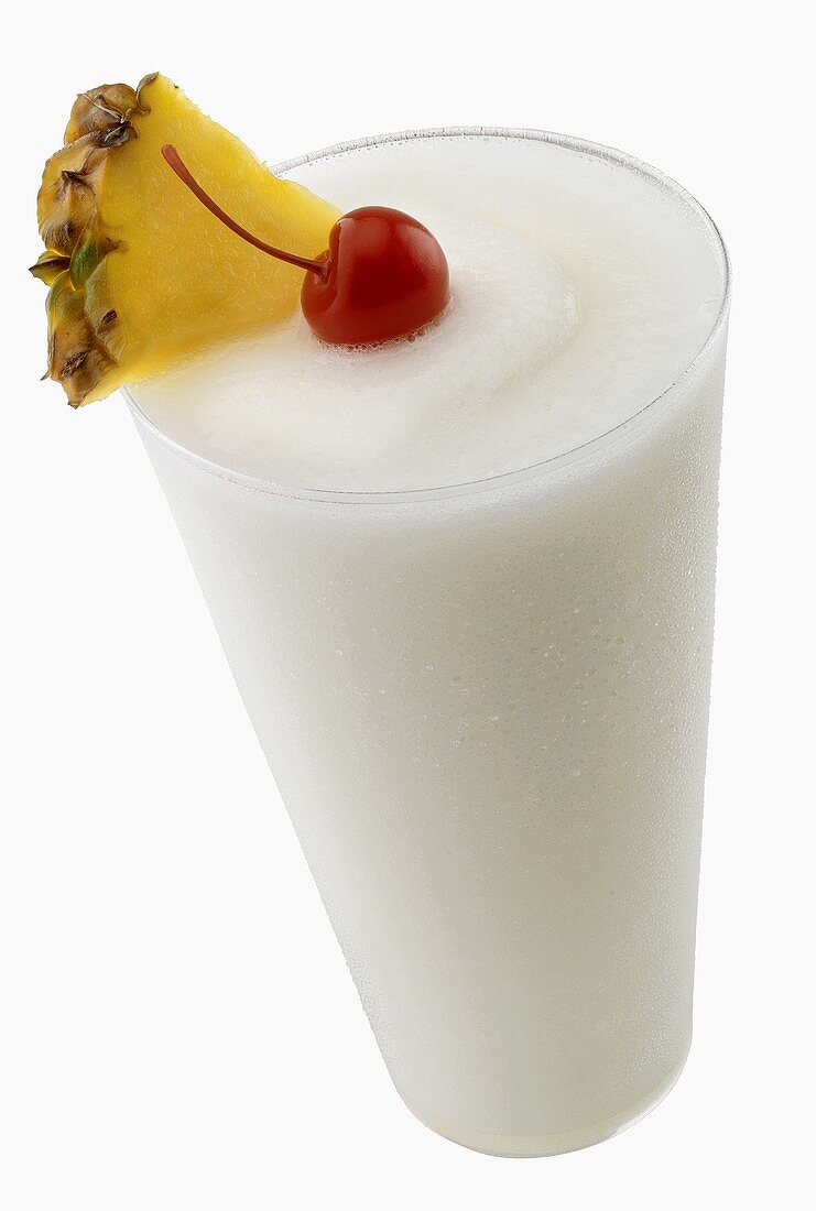 Pina Colada garnished with pineapple and cocktail cherry