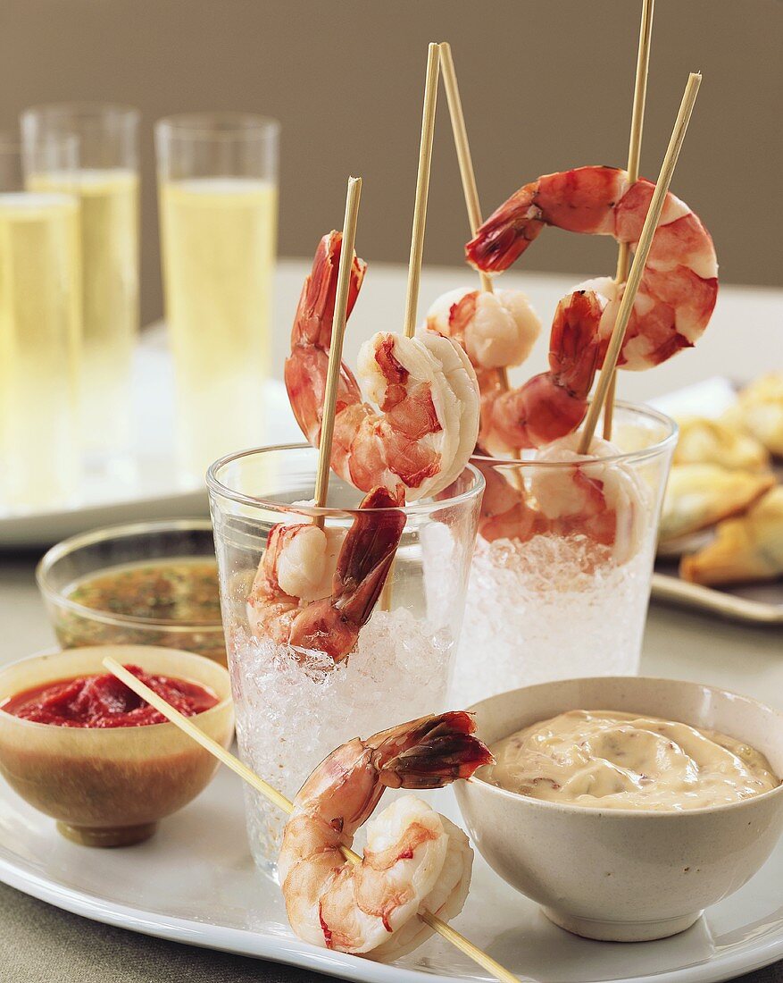 Skewered Cooked Shrimp on Ice with Various Dips