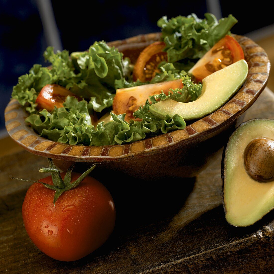Salad with Tomato and Avocado in a Bowl, Tomato and Half an Avocado