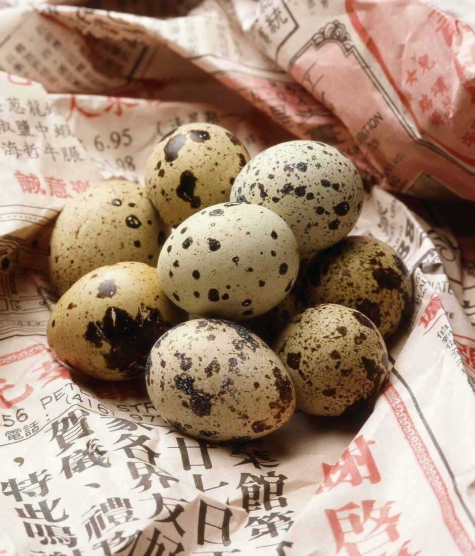 A Pile of Fresh Quail Eggs on Asian Newspaper