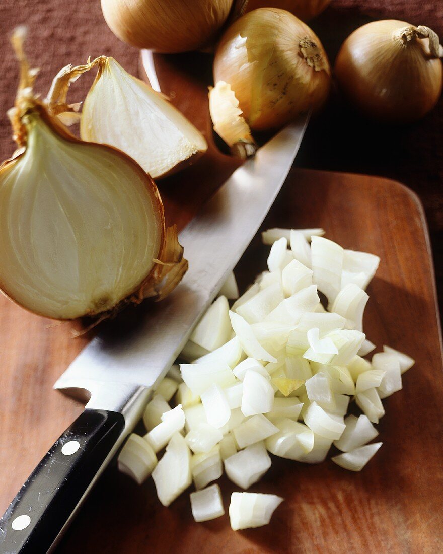 Diced Yellow Onions on Chopping Board with Knife