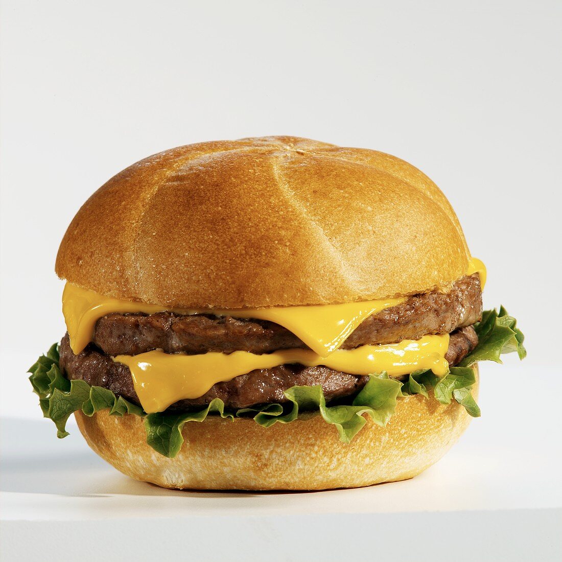 Double Cheeseburger with Lettuce on a White Background