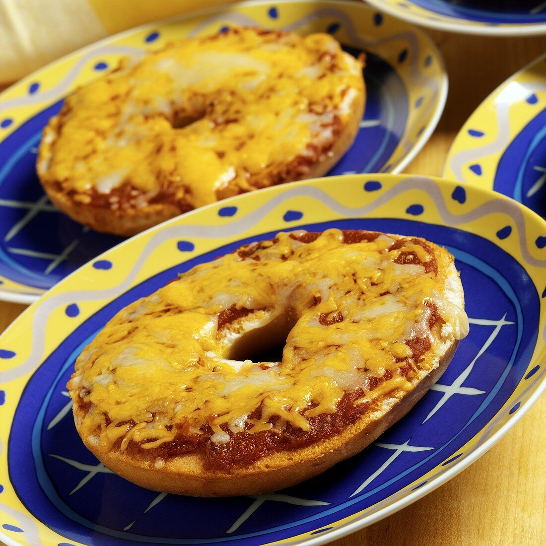 Bagel Pizza with White and Yellow Cheese on a Plate