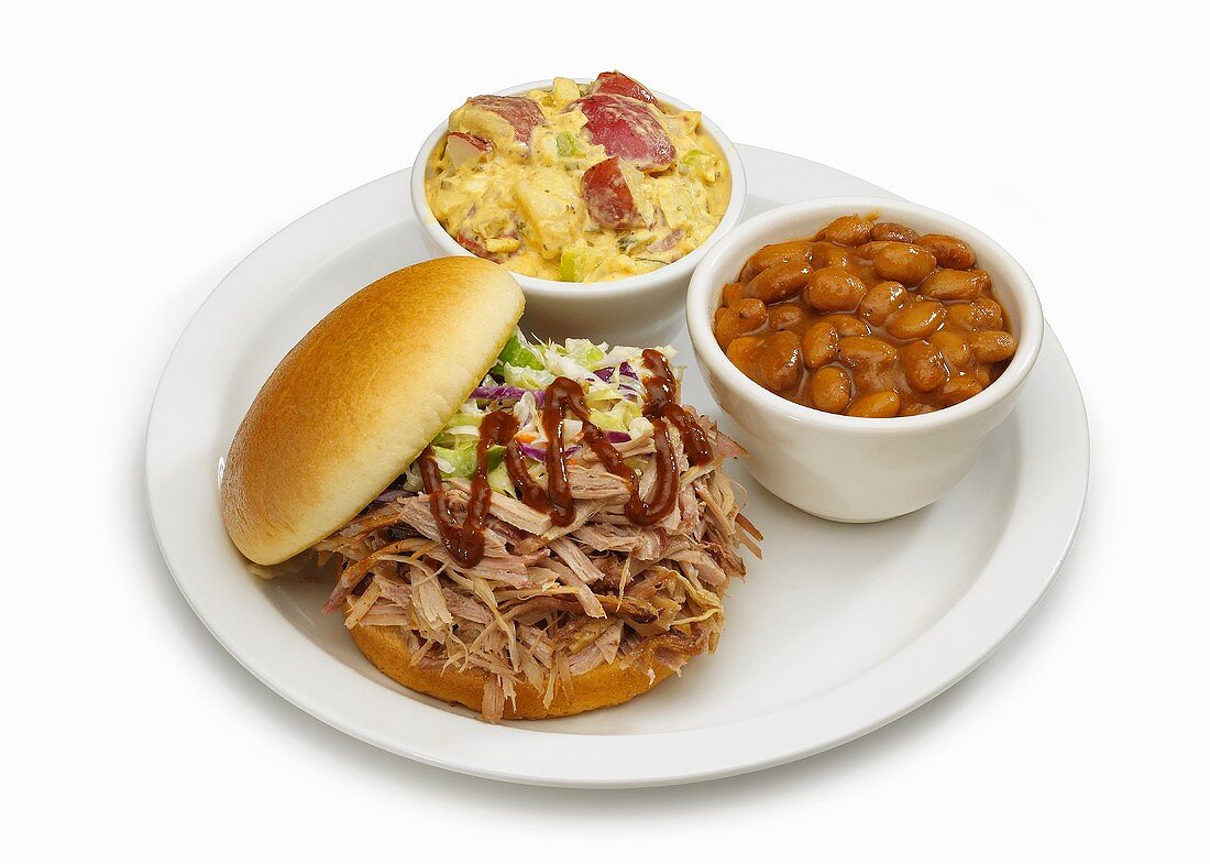 Pork sandwich with baked beans and potato salad