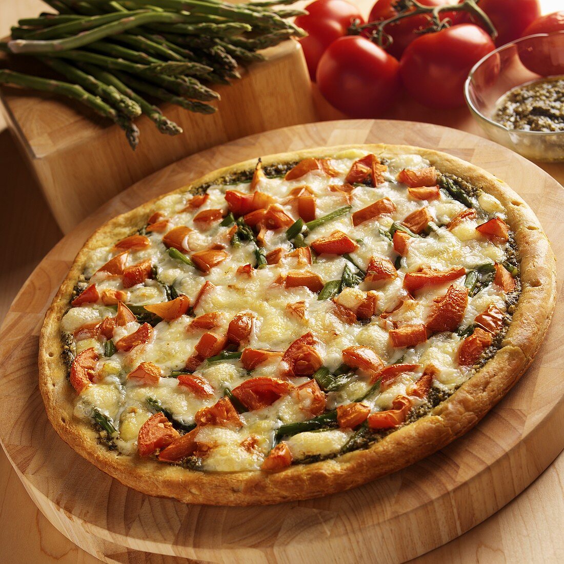 Asparagus, Tomato and Pesto Pizza on Wooden Cutting Board