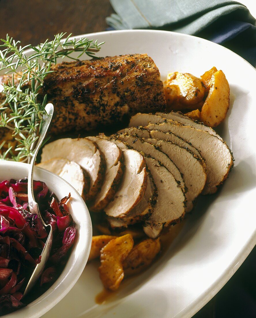 Sliced pork fillet with apples, red cabbage and rosemary