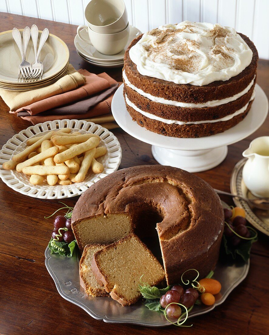 A Dessert Buffet with Bundt Cake, Layered Carrot Cake with Frosting and Finger Cookies