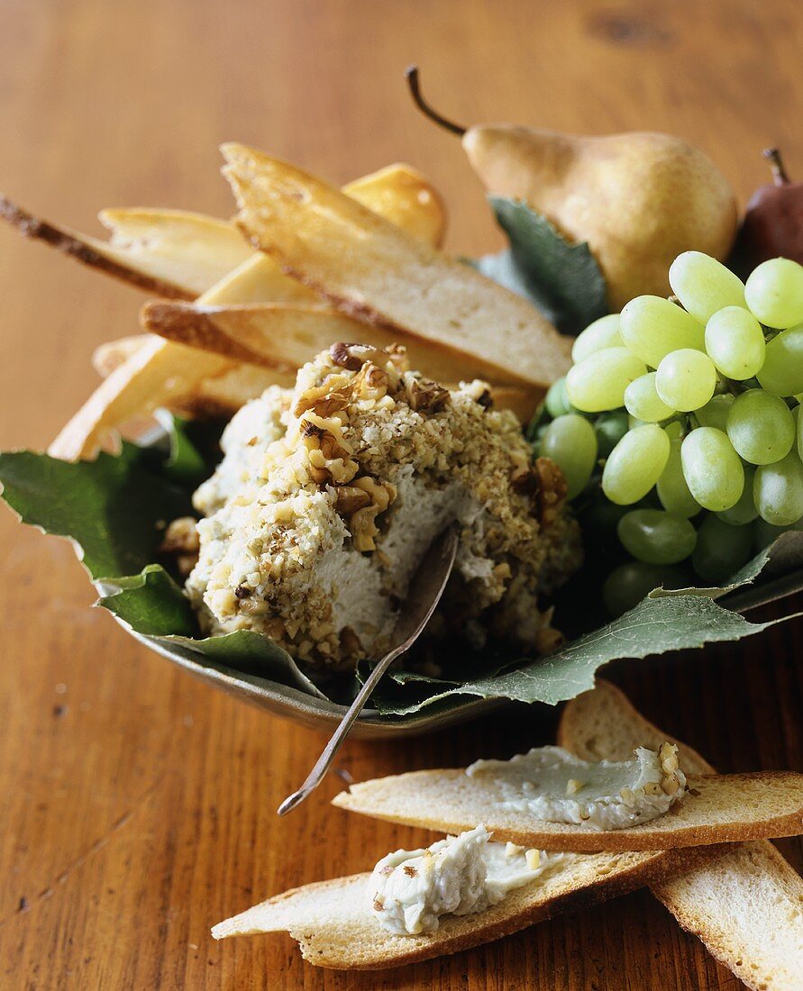 Cheese ball with nuts, Melba toast, grapes, pear