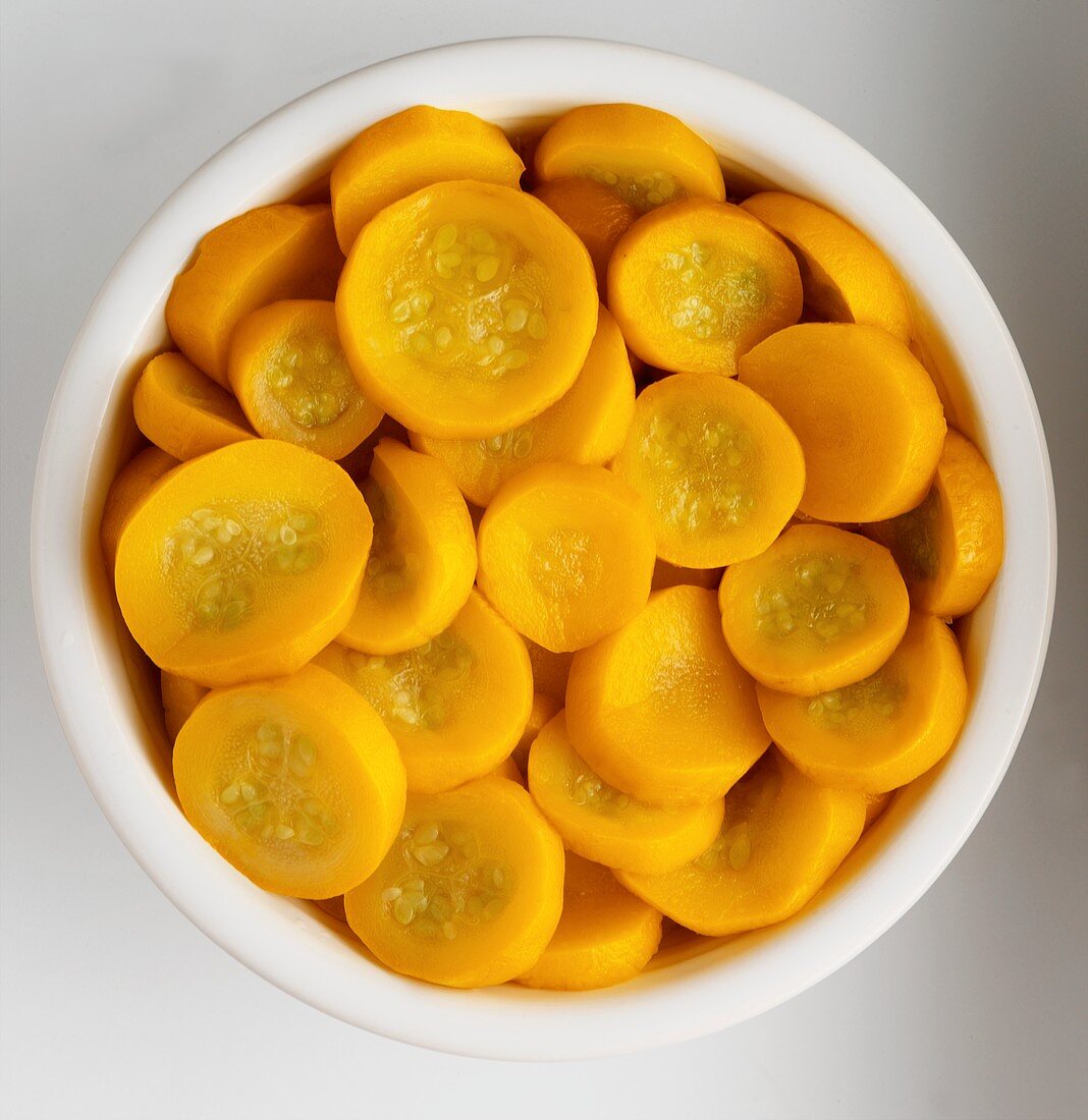 Overhead of a Bowl of Sliced Crookneck Squash