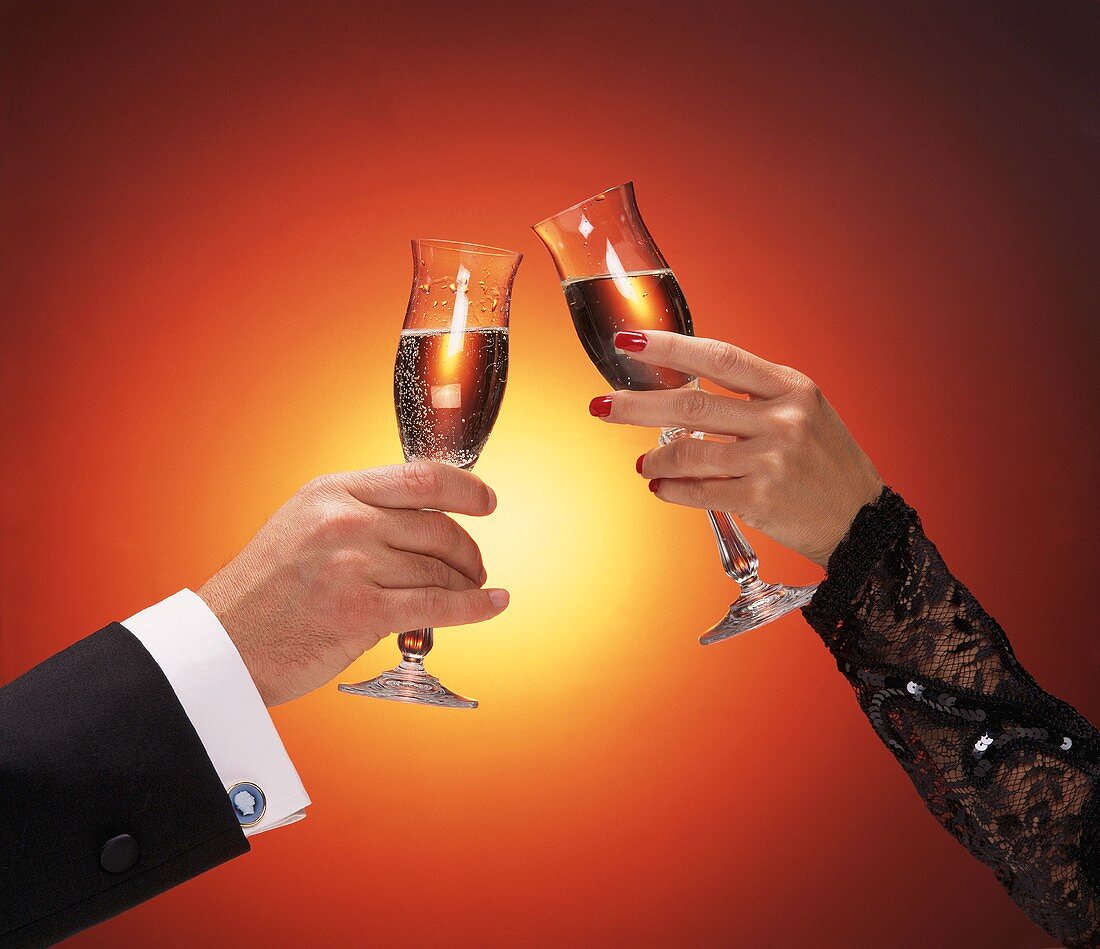 Hands of Couple Toasting with Champagne Glasses
