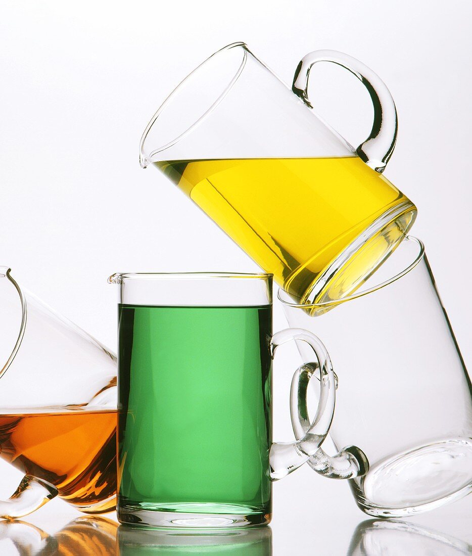 Glass jugs with various different coloured drinks