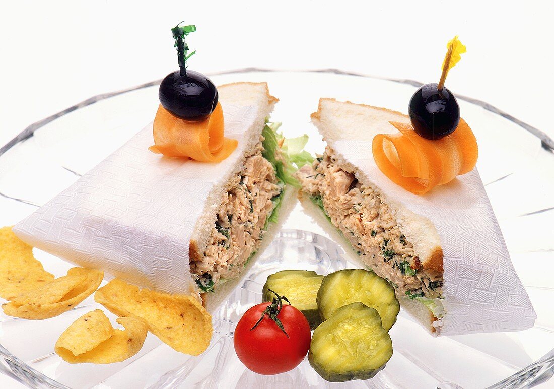 Sliced Tuna Salad Sandwich with Corn Chips and Olive Garnish
