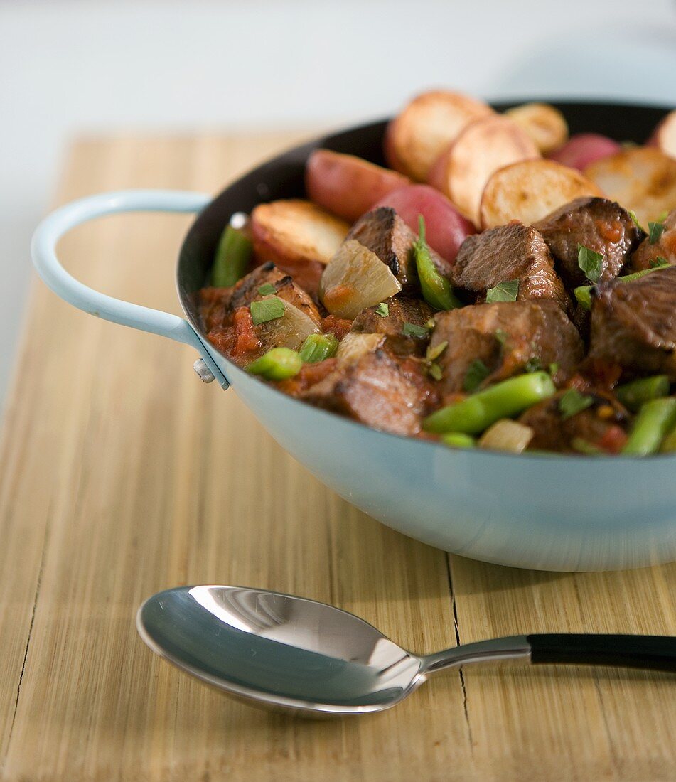 Beef with vegetables, tomato sauce and red potatoes