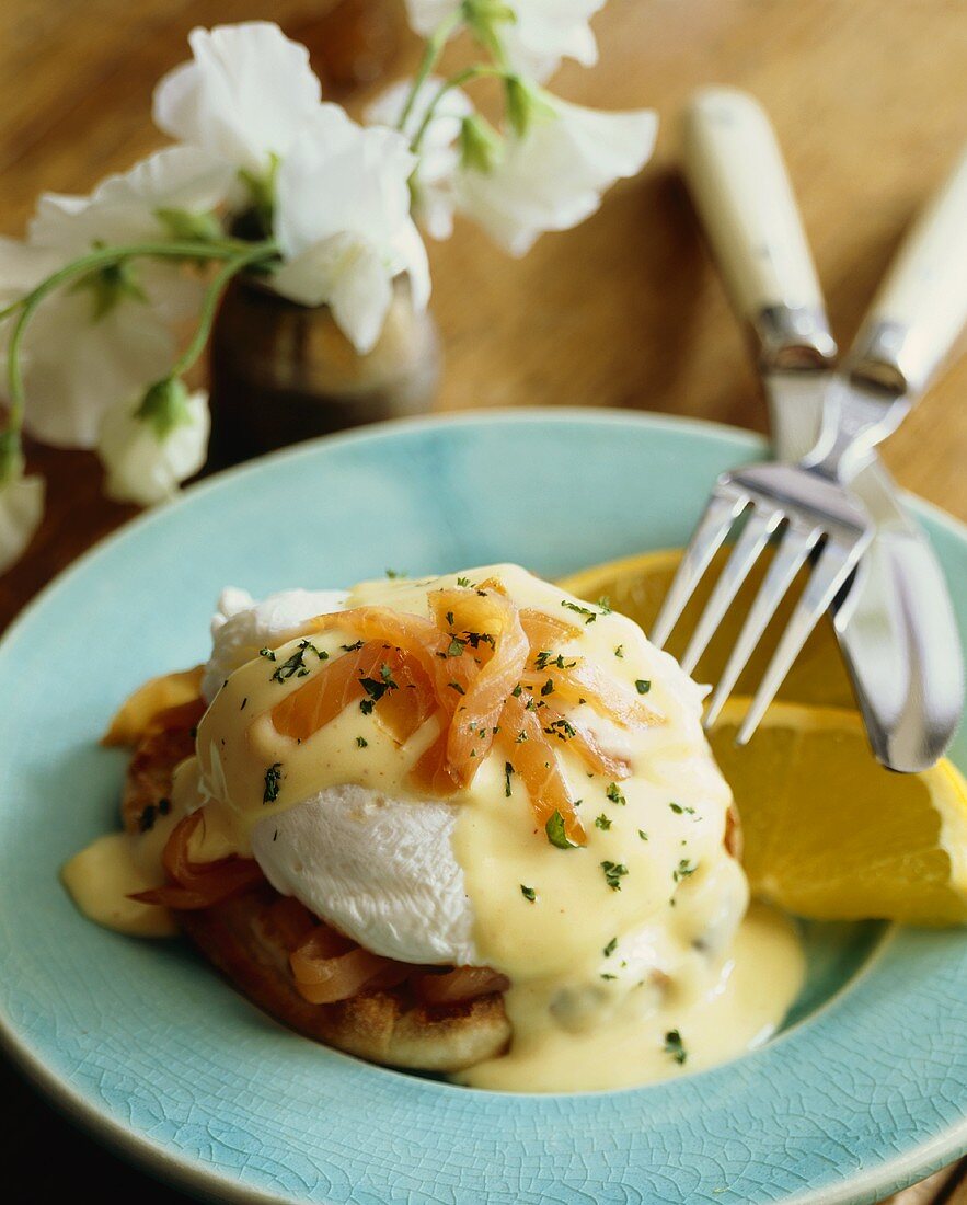 Poached Egg on an English Muffin with Salmon and Hollandaise Sauce; Fork and Knife