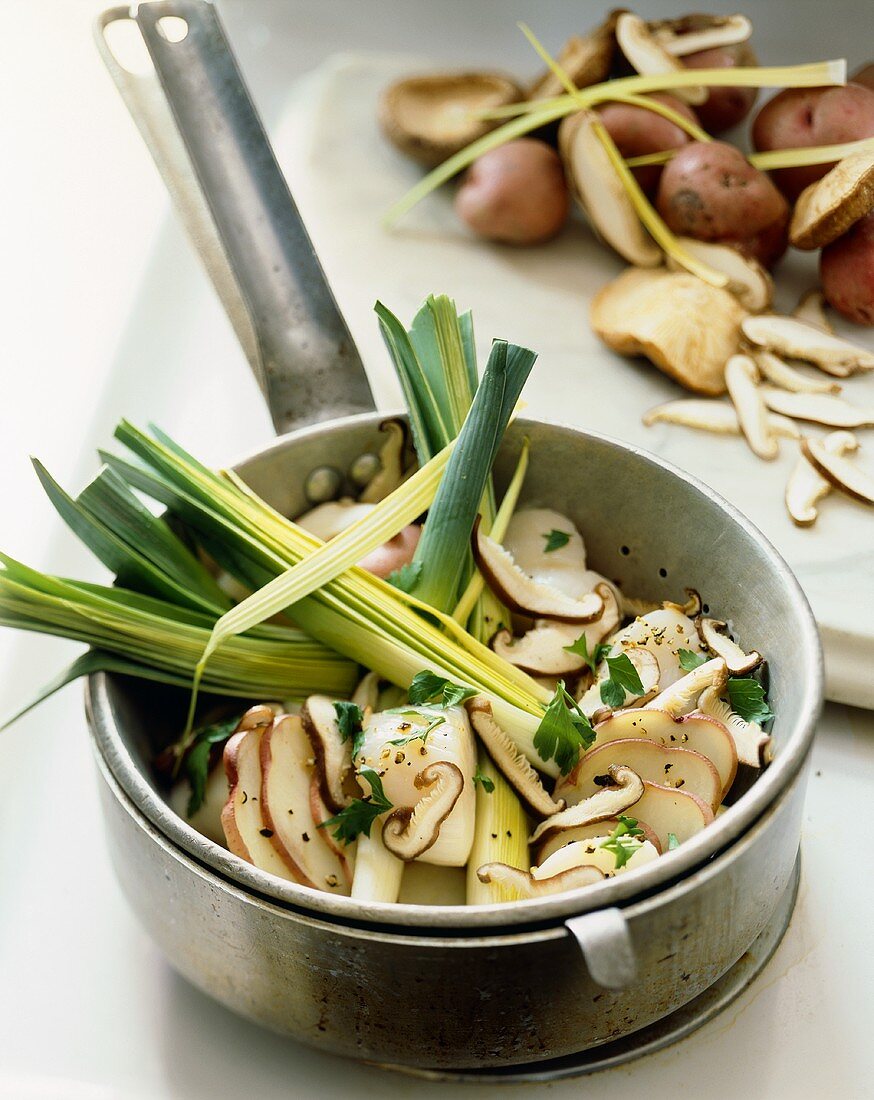 Soup Ingredients in a Pot; Leeks, Mushrooms and Sliced Potatoes
