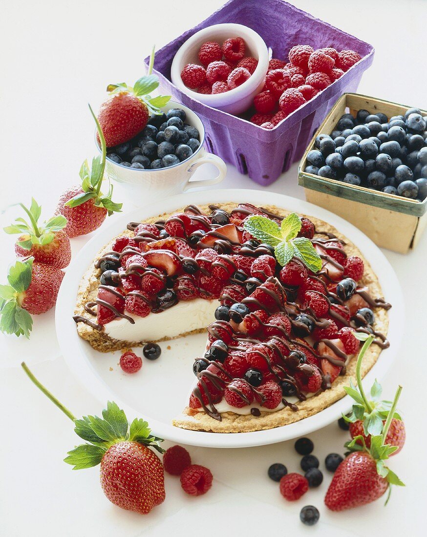 Cheesecake Topped with Fresh Berries and Chocolate Sauce, Slice Removed, Fresh Berries
