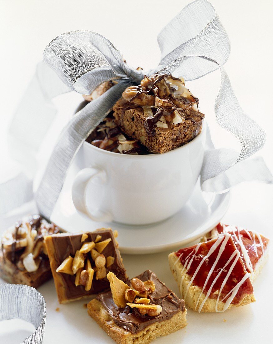 Assorted Dessert Squares In and Beside a Mug Wrapped in Ribbon