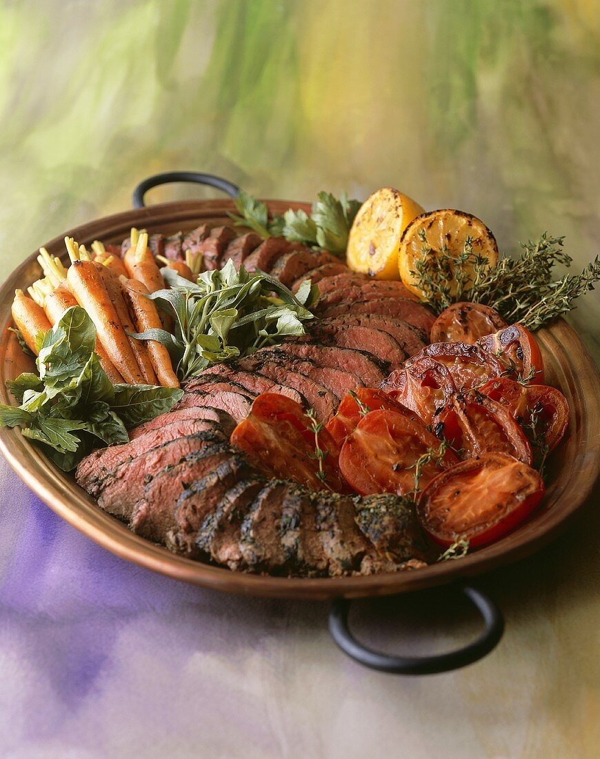Sliced Herbed Beef on Platter with Roast Vegetables