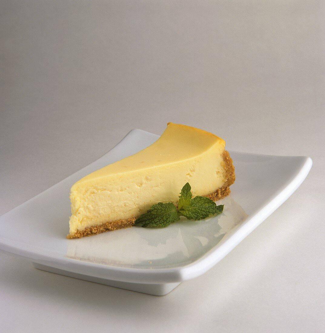 Slice of Cheesecake with Mint Garnish