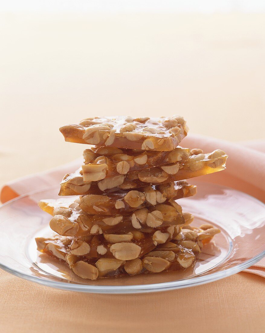 Stacked Peanut Brittle on a Glass Plate