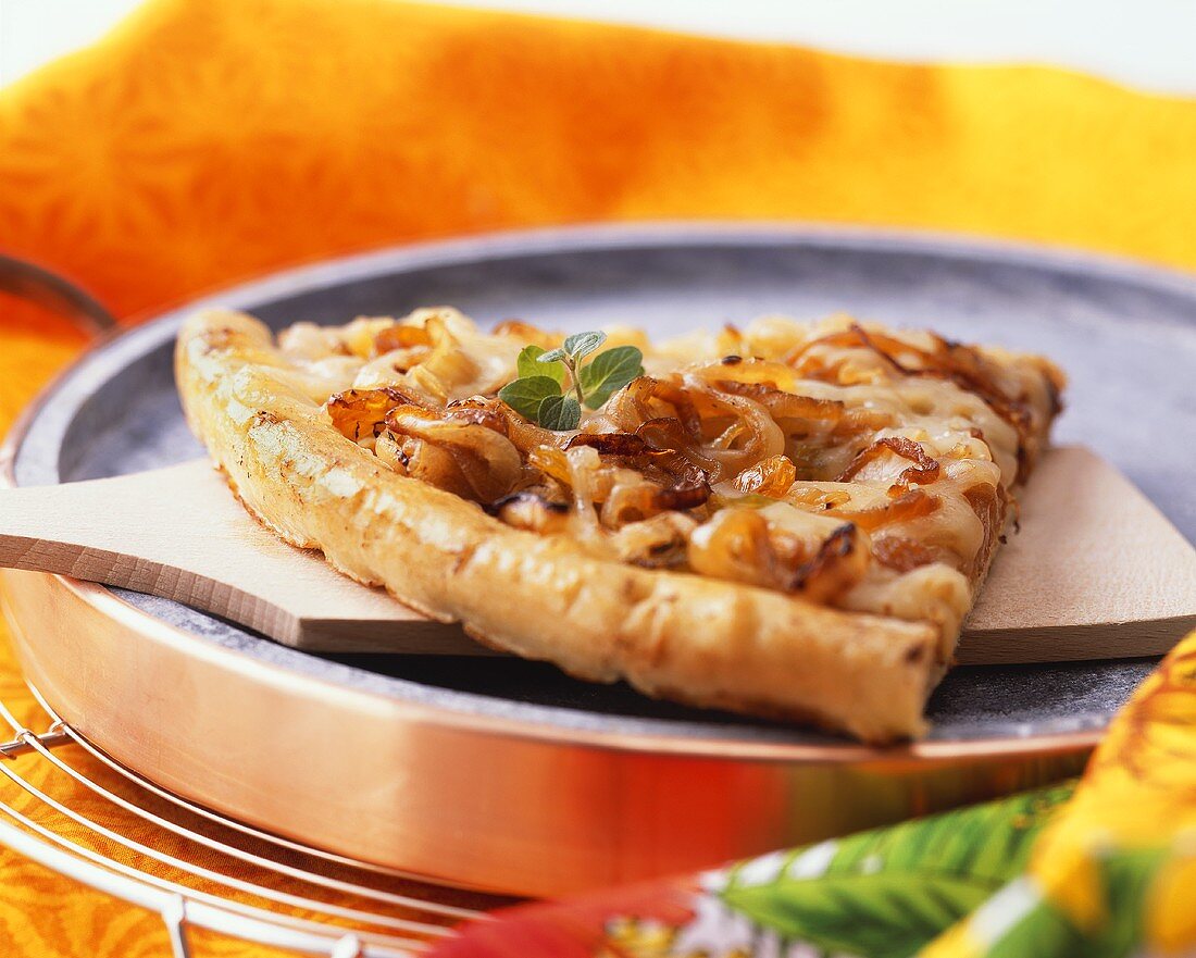 Slice of pizza with caramelised onions