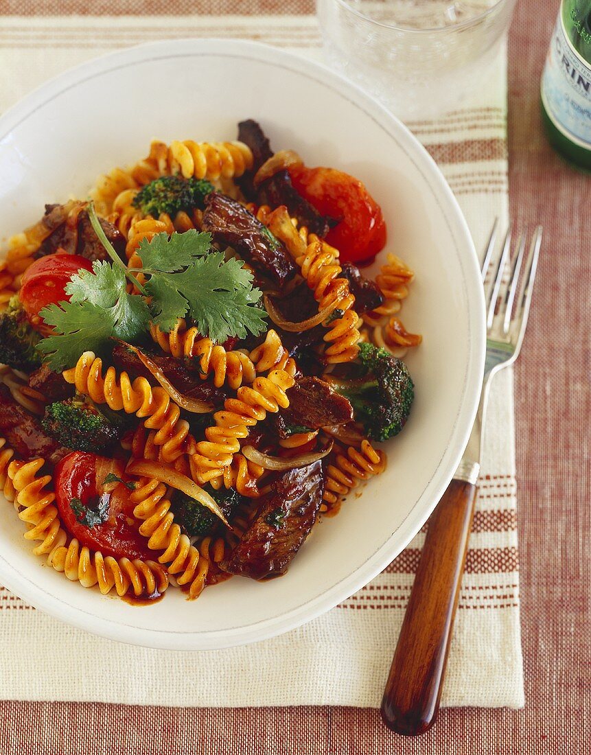 Grilled Steak and Tomato Pasta on a White Plate