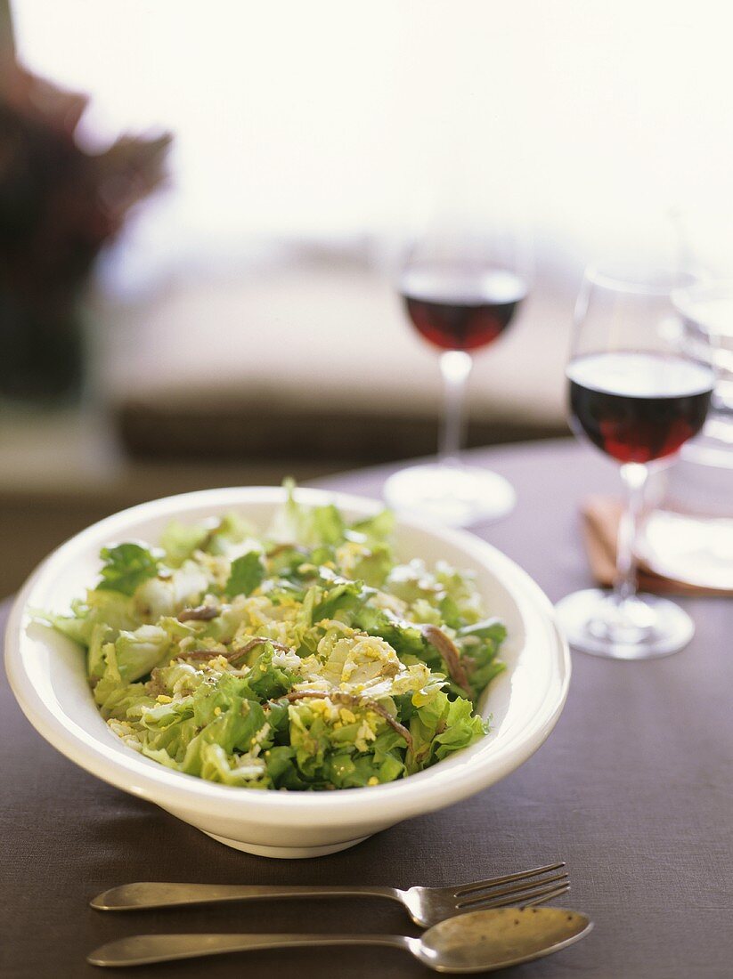 Escarole Salad with Egg and Anchovies; Glasses of Red Wine