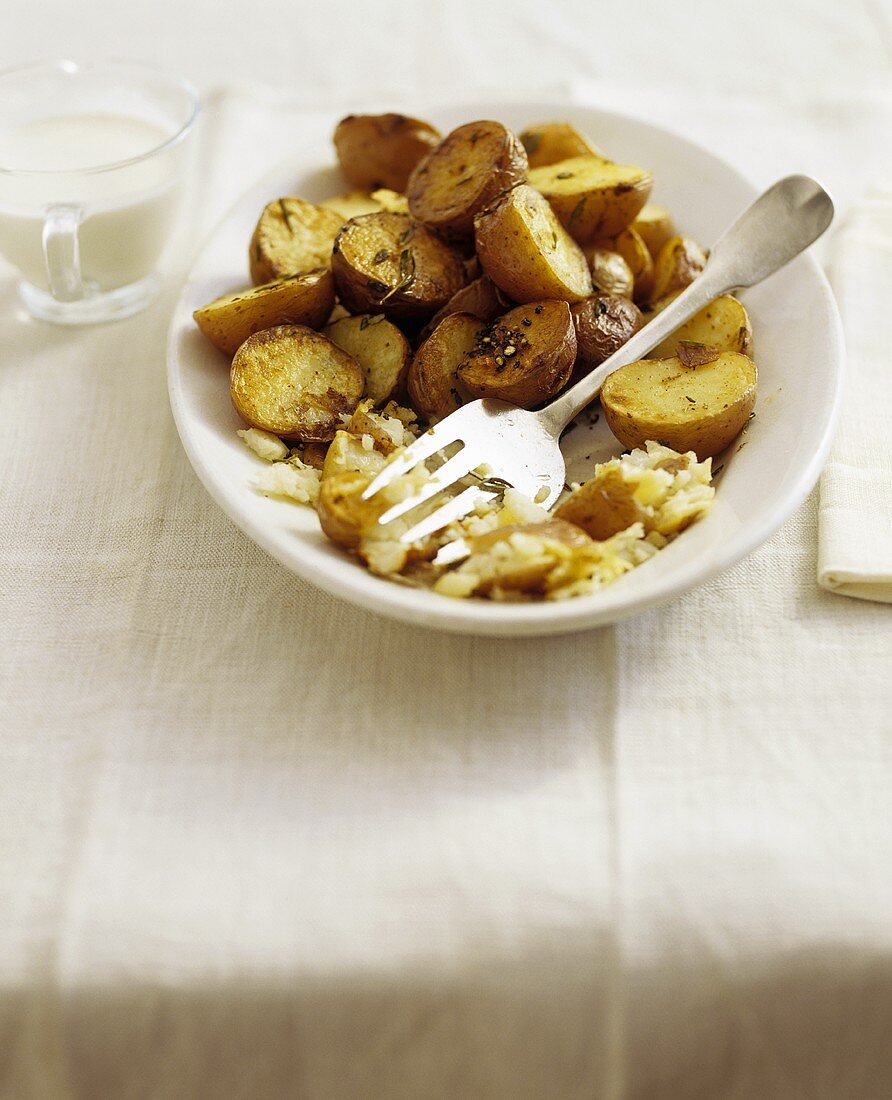 Herb Roasted Potatoes in Serving Dish; Serving Fork