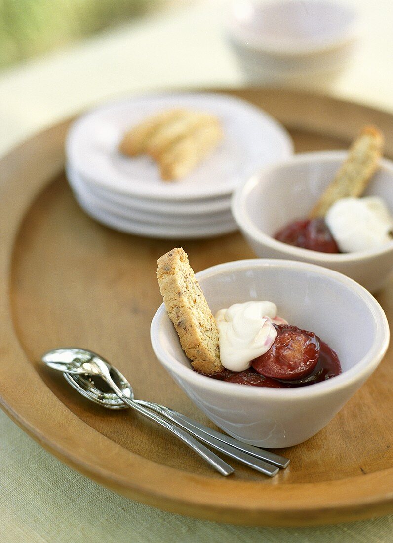Bowls of Stewed Plums with Cream and Biscotti