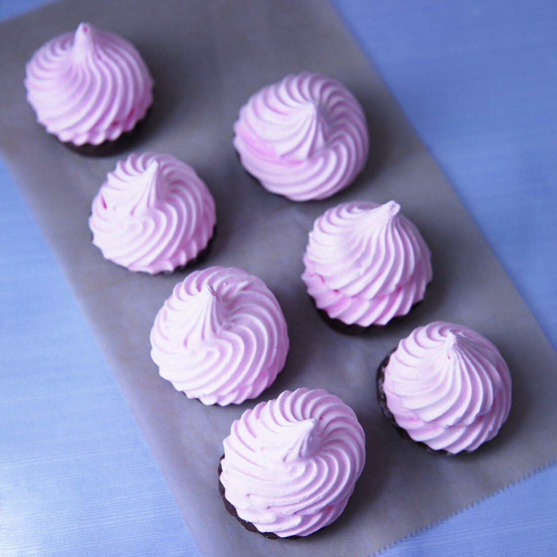 Pink Meringues Dipped in Dark Chocolate; From Above