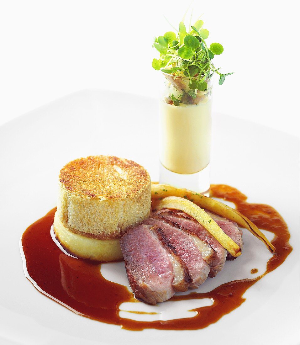 Duck breast with apple charlotte with parsnip puree and radish sprouts