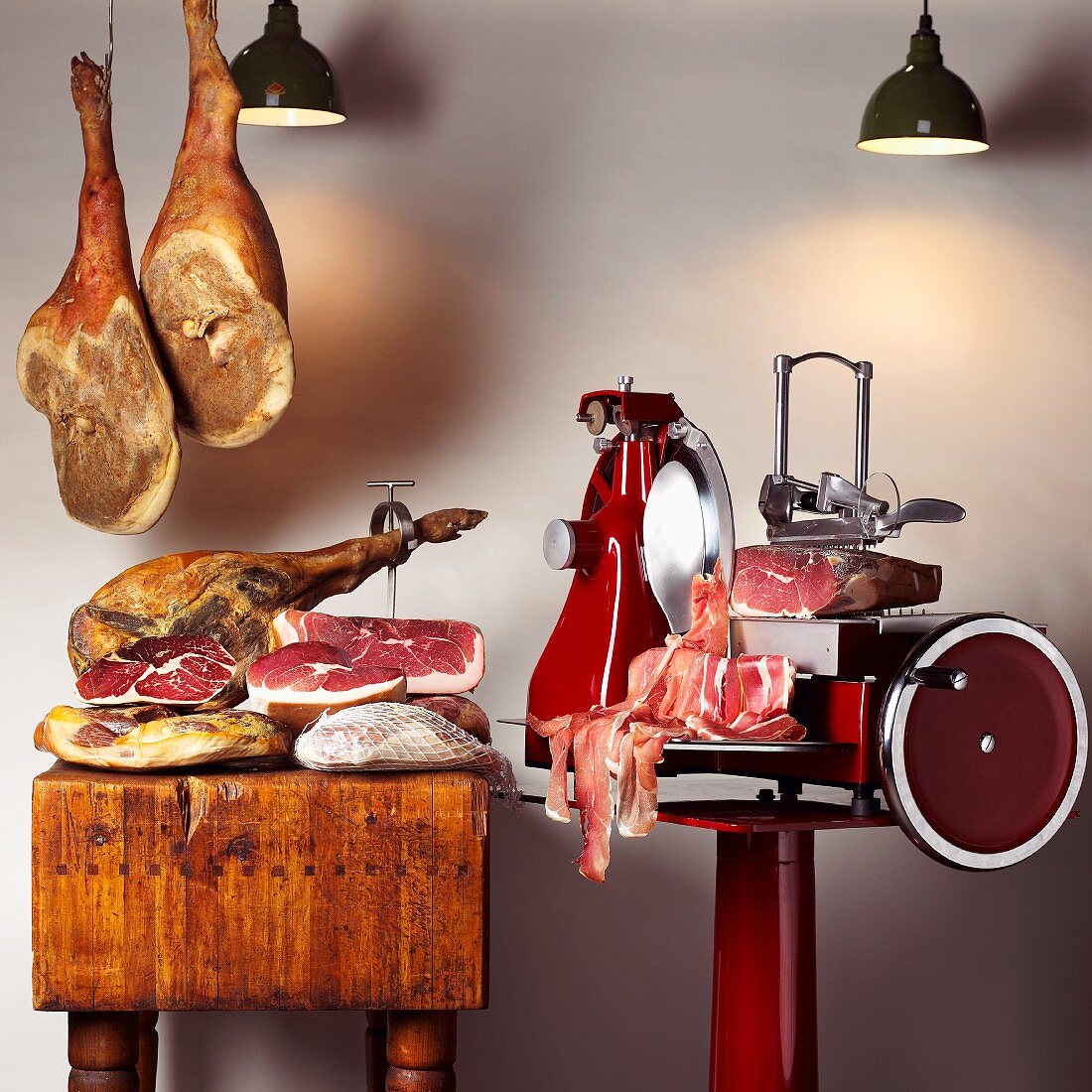 An arrangement of various raw hams and a sewing machine