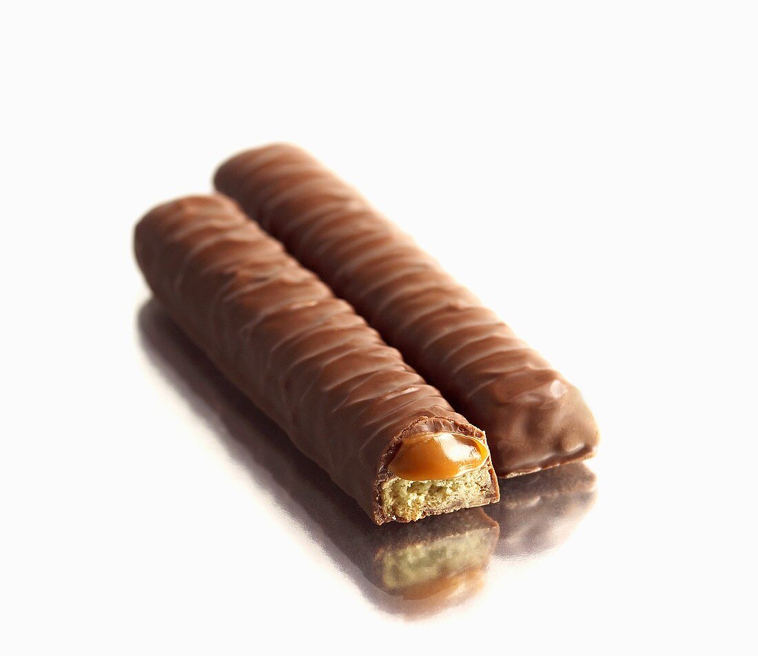 Two Twix Bars on White; One with Broken End