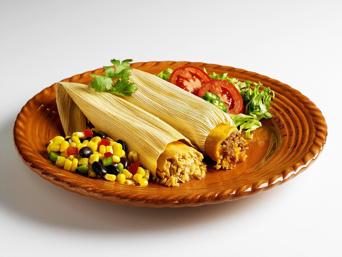 Chicken and Beef Tamales on a Plate with Corn Salad
