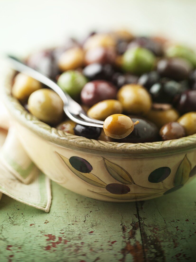 Bowl of Mixed Olives with a Fork